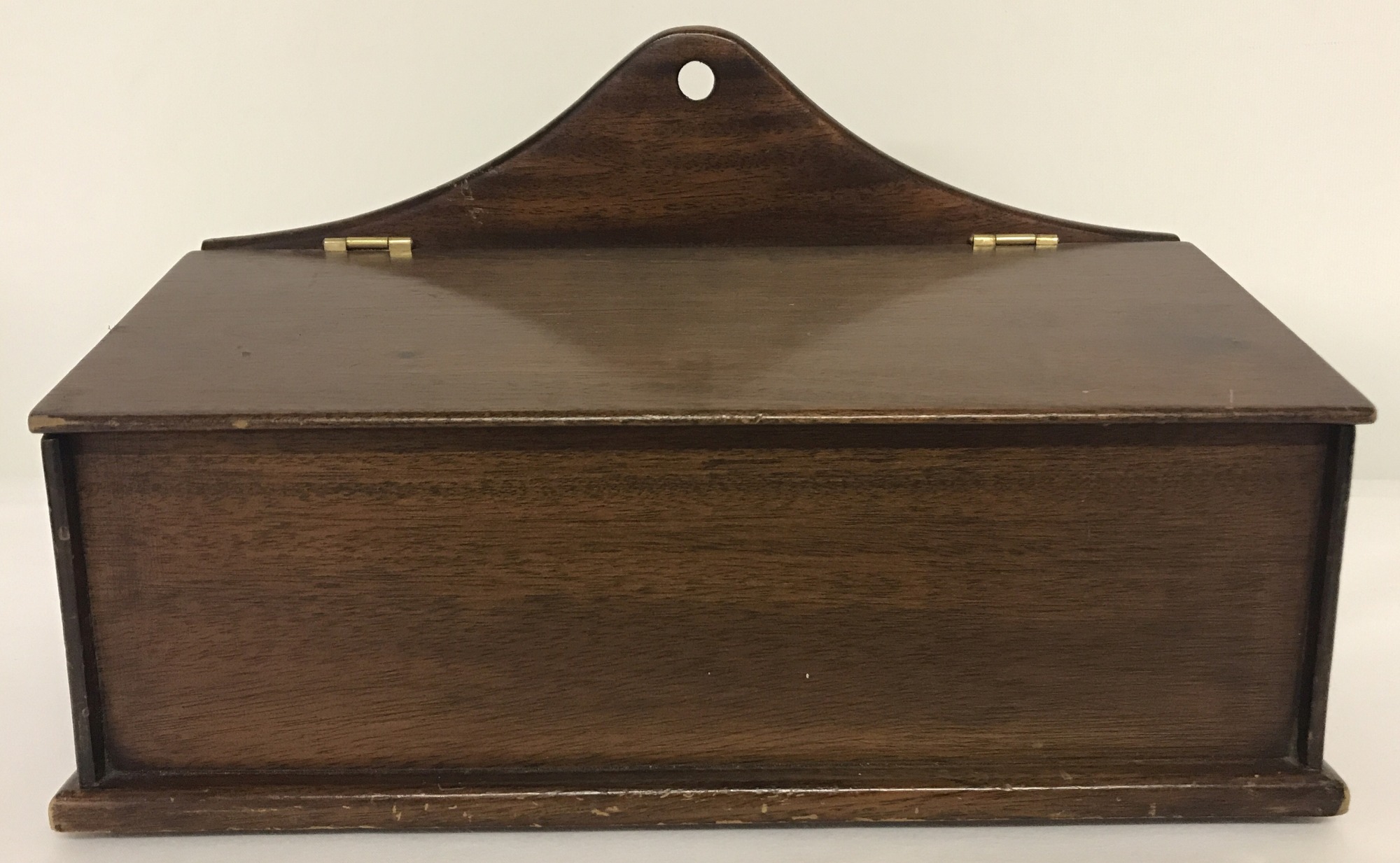 A vintage mahogany candle box with brass hinges.