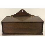 A vintage mahogany candle box with brass hinges.
