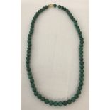 A malachite bead necklace with 18ct gold clasp. Total length 16 inches.