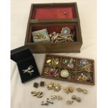 A vintage jewellery box containing an assortment of vintage and modern costume jewellery.