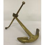 A solid brass paperweight in the shape of an anchor.