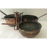 A collection of vintage copper cooking utensils to include large saucepans.