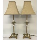 A pair of gold and white column style table lamps.