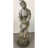 A heavy vintage concrete garden ornament of a classical lady carrying a dove.