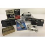 A box of 5 digital and vintage cameras and accessories.