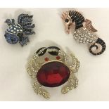 3 costume jewellery stone set brooches in the shape of sea creatures.