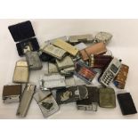 A collection of vintage lighters, a travel razor, a Rolls razor head and a brass vesta case.