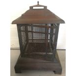 A metal garden fire pit/cage in the shape of a pagoda.