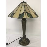 A Tiffany style table lamp with iridescent glass panels decorated with leaves.