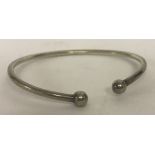 A silver torque bangle.