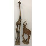 2 large carved wooden animal figures. A giraffe with burnt wood pattern