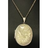 A vintage silver locket on a 20" fine curb chain.