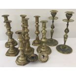 A quantity of 9 assorted brass candlesticks.