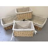 A collection of modern storage baskets, natural colouration with fabric inserts.