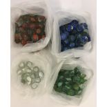 A collection of red, blue, green and white vintage cats eye marbles.