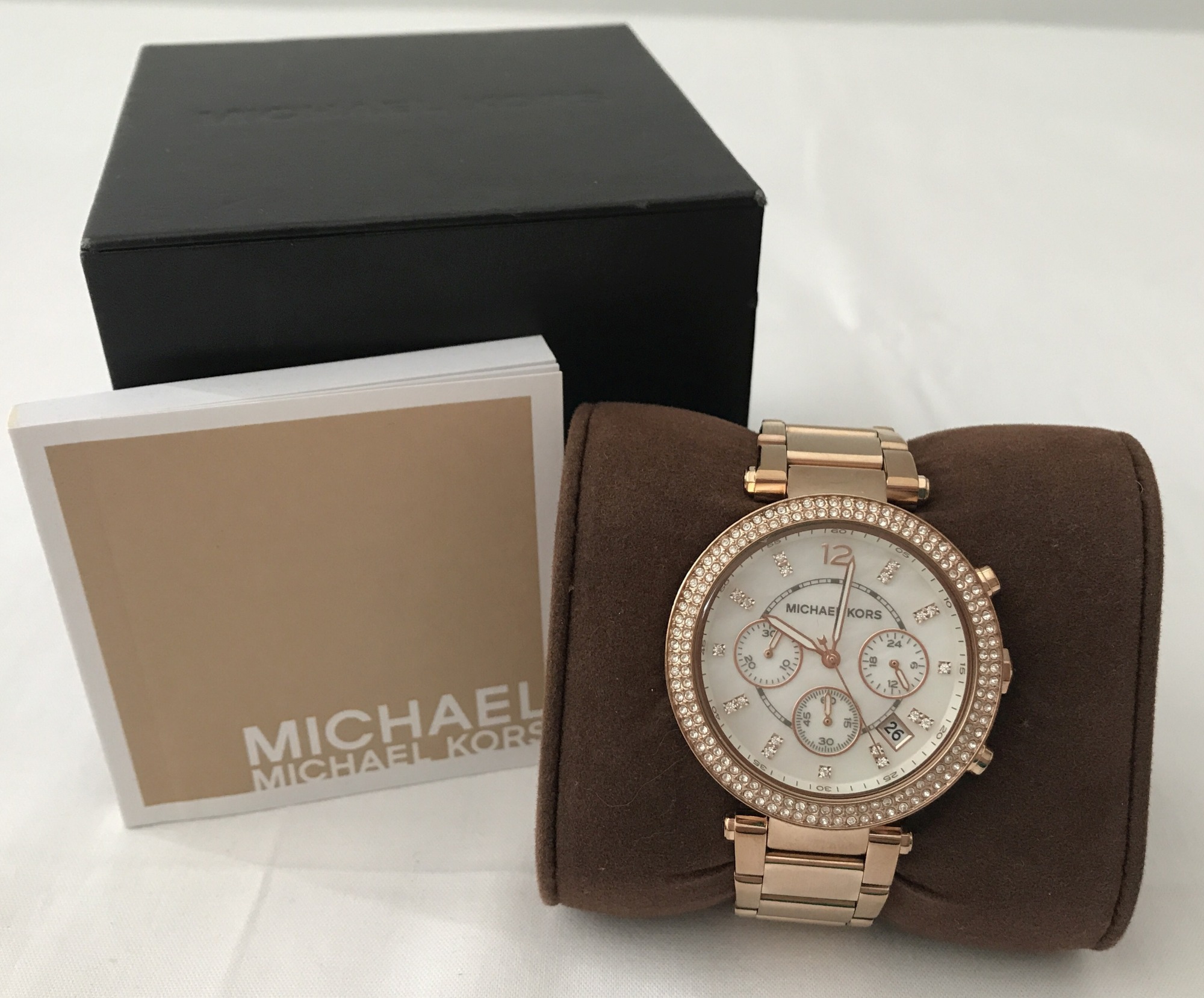 A boxed Michael Kors ladies rose gold tone chronograph wrist watch.