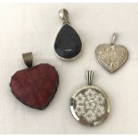 4 decorative silver pendants. All marked 925 or sterling.
