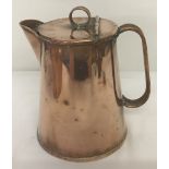 An antique copper lidded jug.