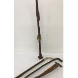 A collection of vintage walking sticks to include horn handled.