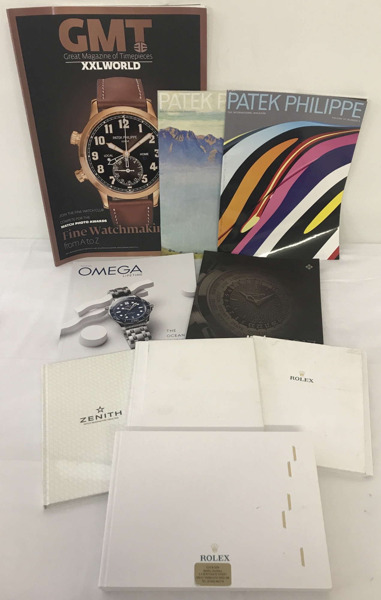 A collection of watch catalogues and magazines.