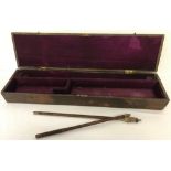 A vintage wooden gun case with purple felt lining.