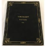 A leather bound copy of Torchlight Tattoo 1934 containing autographs.
