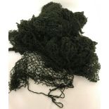 A quantity of 28 British modern dark green helmet nets.