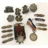 A collection of assorted medals, bars and badges.