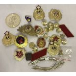 A bag of Cold War style metal Soviet badges and insignia.