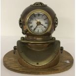 A model of a brass and copper divers helmet made into a desk clock.