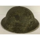 WWII era British MK II steel helmet with camouflage finish.