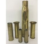 A collection of WWI and WWII military brass shells.