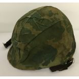 Vietnam war era US MK1 steel helmet with salty cover.