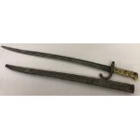 A 19th century French Chassepot bayonet in a metal scabbard.