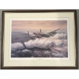 A framed and glazed limited edition print "At The Going Down Of The Sun" of a Lancaster.