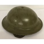 A WWII British MK II steel helmet with early oval liner pad.