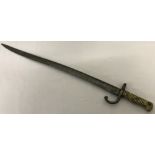 A 19th century French Chassepot bayonet with brass ribbed handle and hooked quillion.