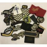 Bag of mixed military cloth badges from different periods.