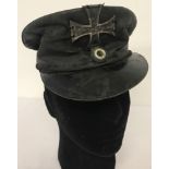 WW1 Style Prussian Land Sturm oil cloth cap with button and metal cap badge.