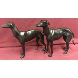 A pair of heavy cast iron greyhound figures.
