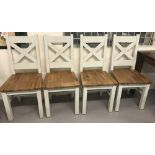 A set of 4 matching heavy wooden dining chairs.