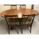 A G Plan draw leaf dining table with 4 matching chairs.