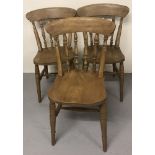 3 vintage pine back kitchen chairs with turned spindles to back.
