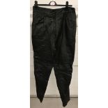 A pair of vintage tapered leg black leather trousers.