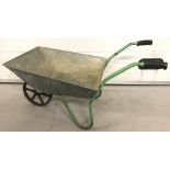 A vintage galvanised wheelbarrow with 6 spoke cast iron wheel.