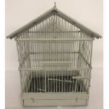 A wooden ornamental birdcage painted grey.