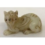 A small Chinese white jade figure, carved into the shape of a Foo dog.