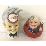 2 cast iron Coca Cola money banks, with painted detail, depicting the Coke Sprite boy.