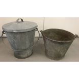 A large galvanised pail with lid together with a vintage galvanised fire bucket.