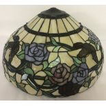 A large Tiffany style glass lampshade with butterfly and rose decoration.